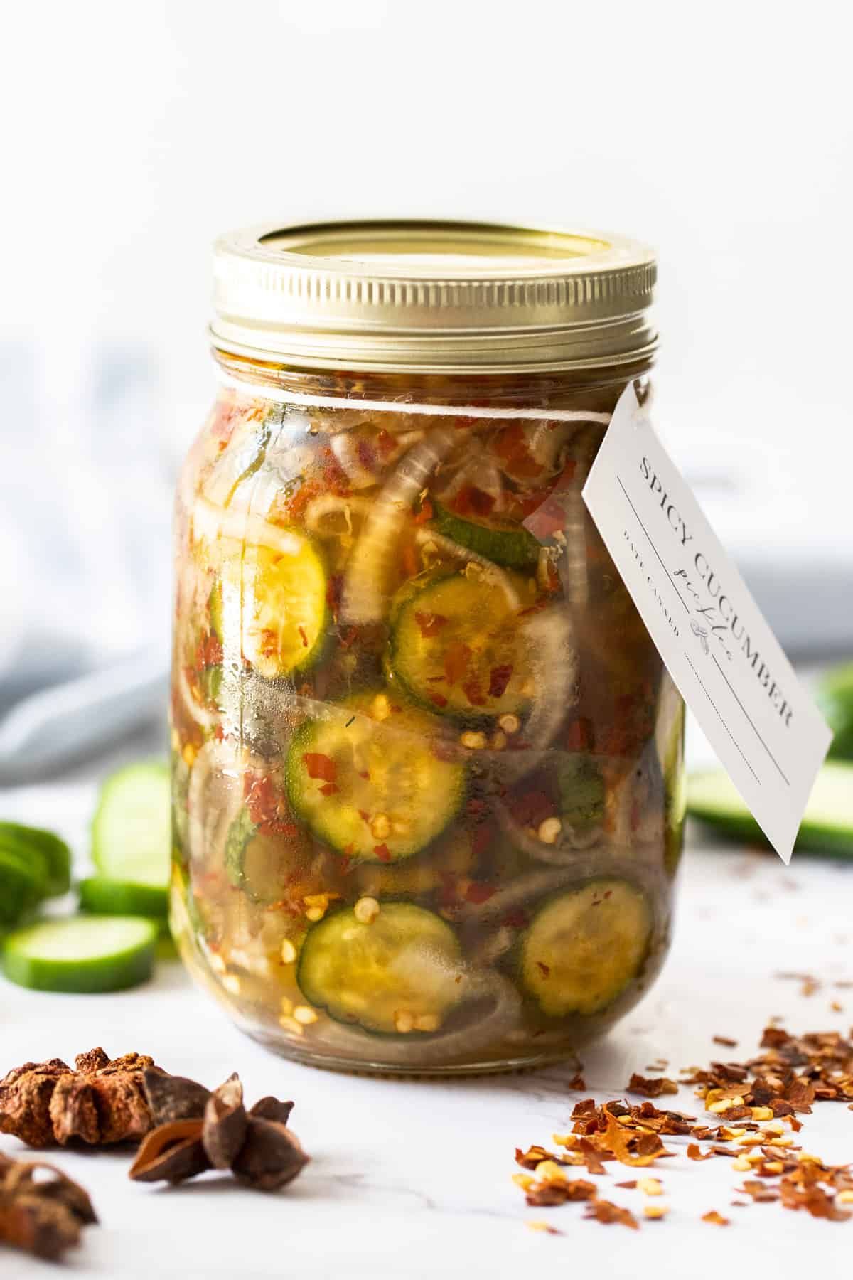 Spicy chili pickles in a glass jar.