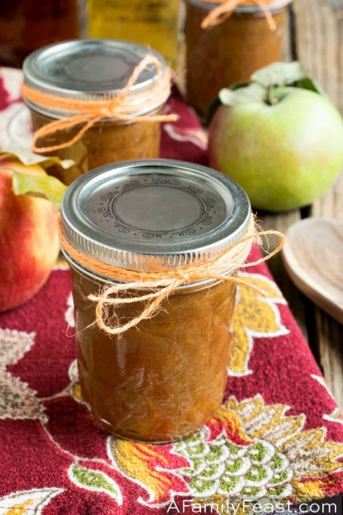 Deliicous bourbon apple butter in glass jars.