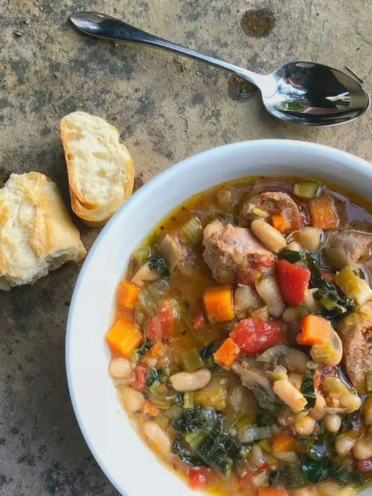 One pot tuscan white bean soup in a white bowl.