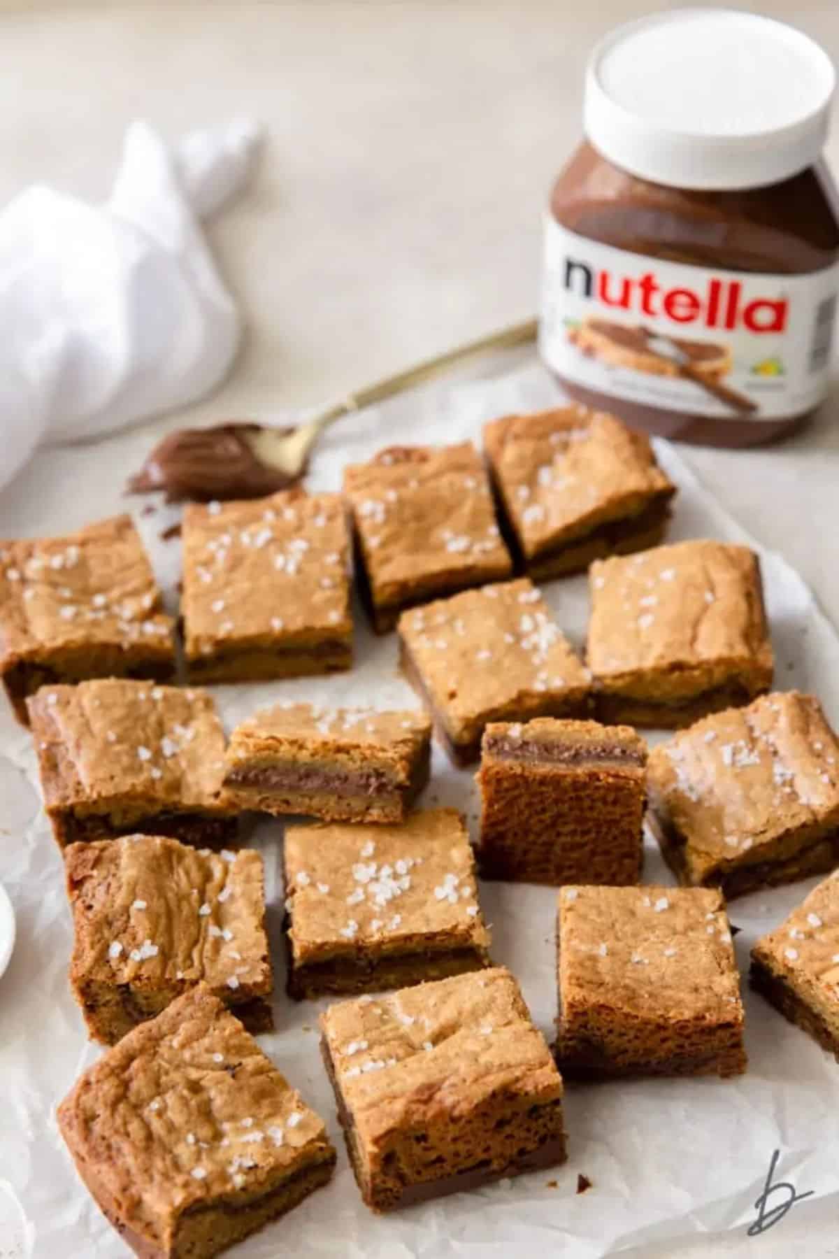 Deliicous salted nutella blondies on parchment paper.