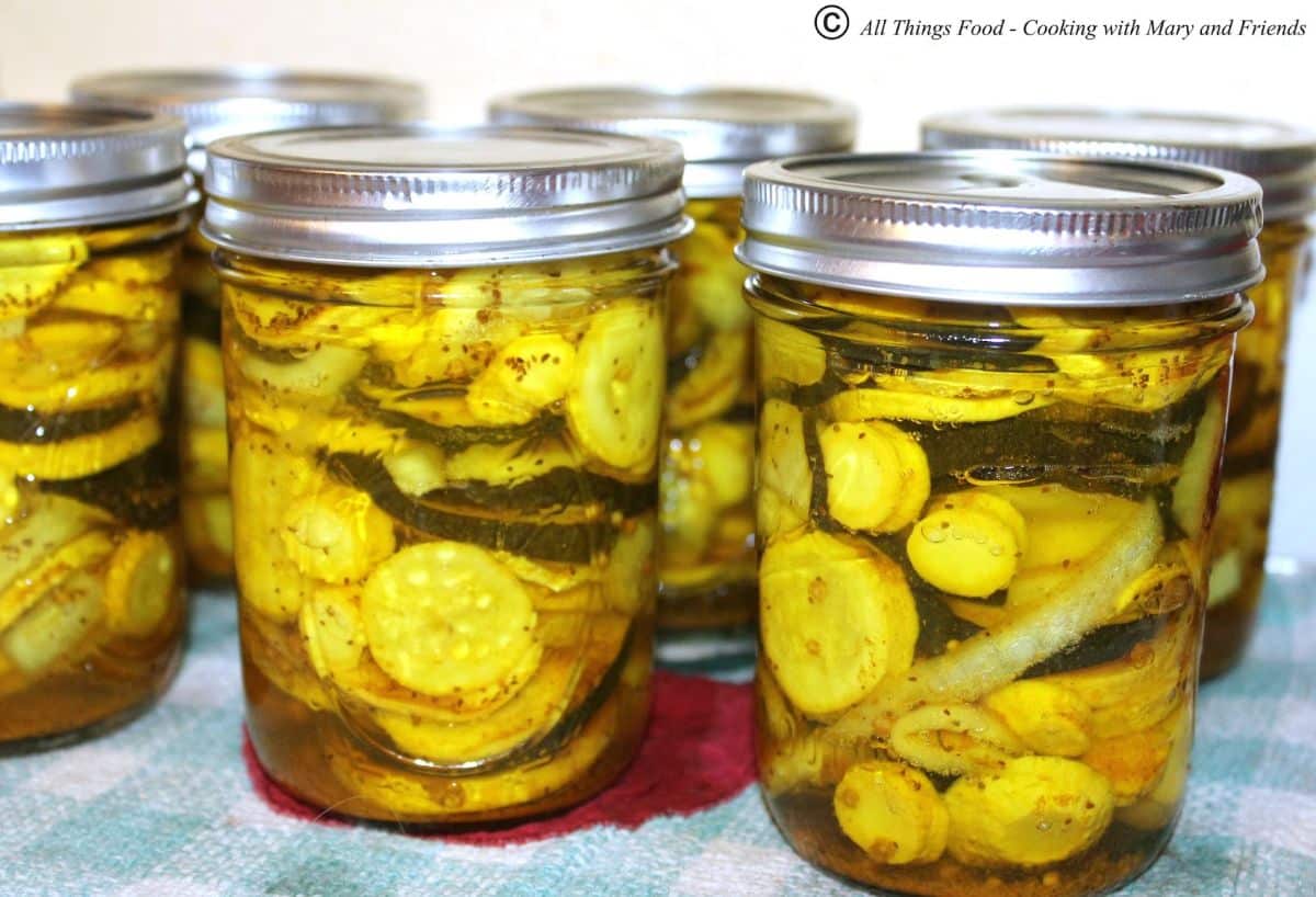 Old fashioned southern squash pickles in glass jars.