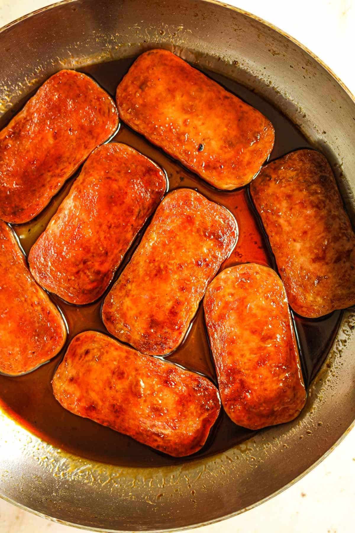 Spam canned meat in a skillet.