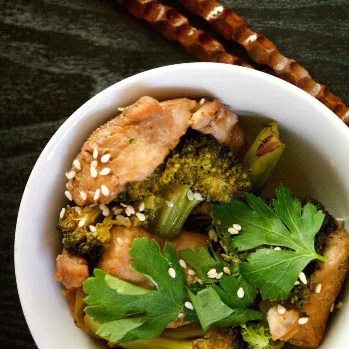 Chicken and broccoli foil dinner in a white bowl.