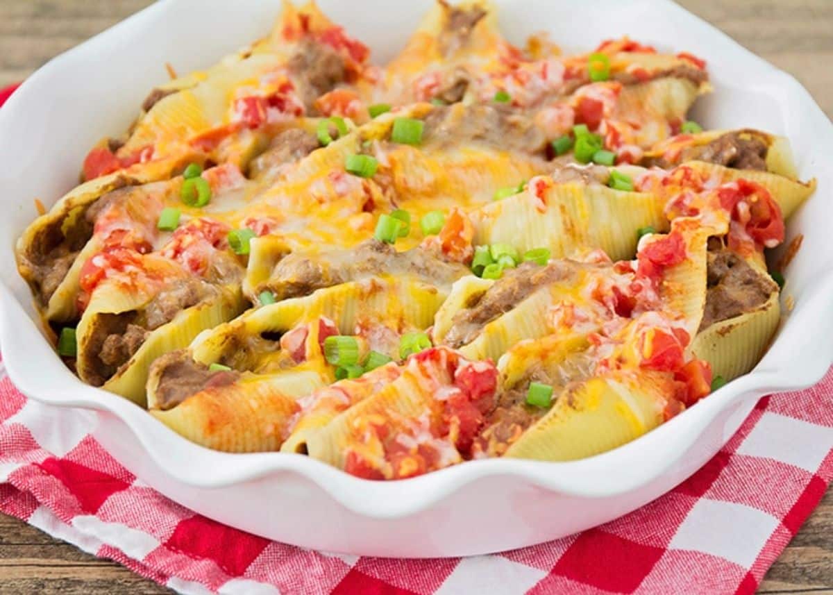 Scrumptious taco stuffed pasta shells in a white bowl.