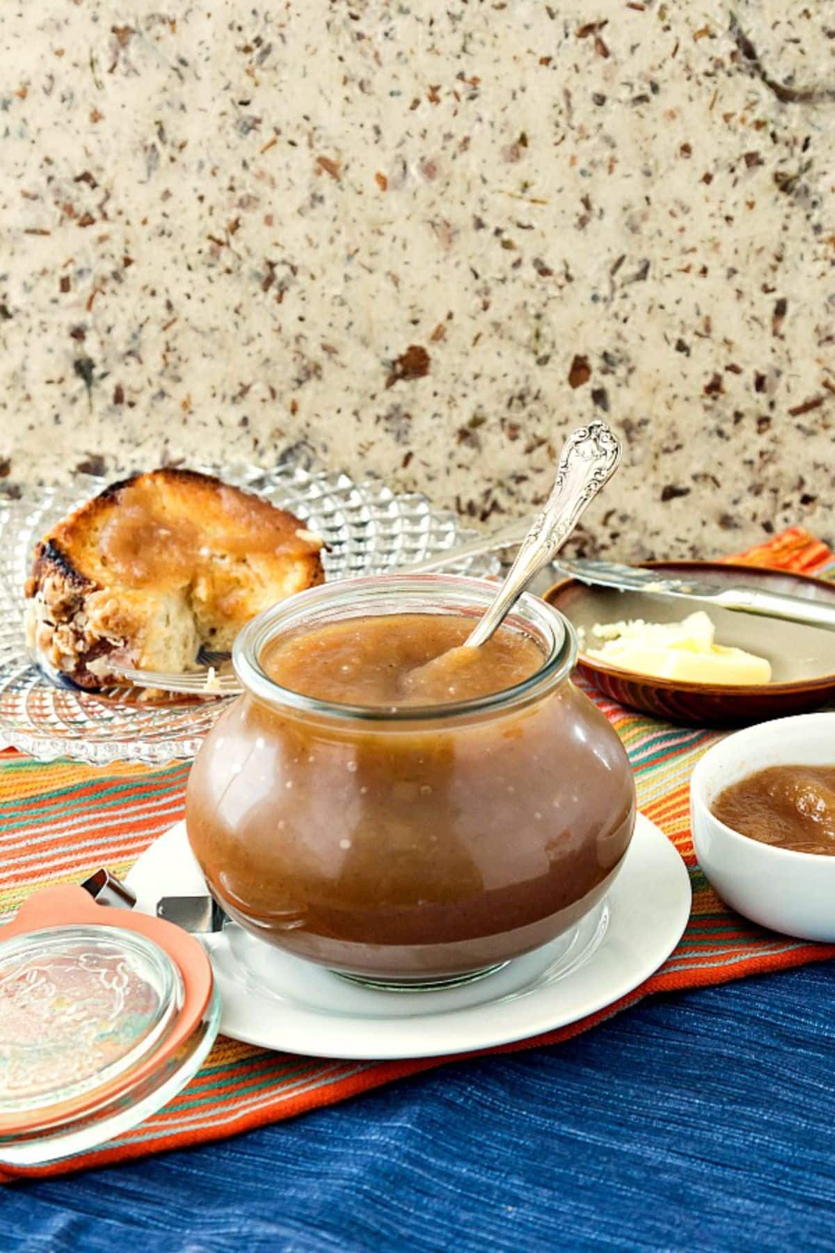 Delicious chai spiced apple butter in a glass jar with a spoon.