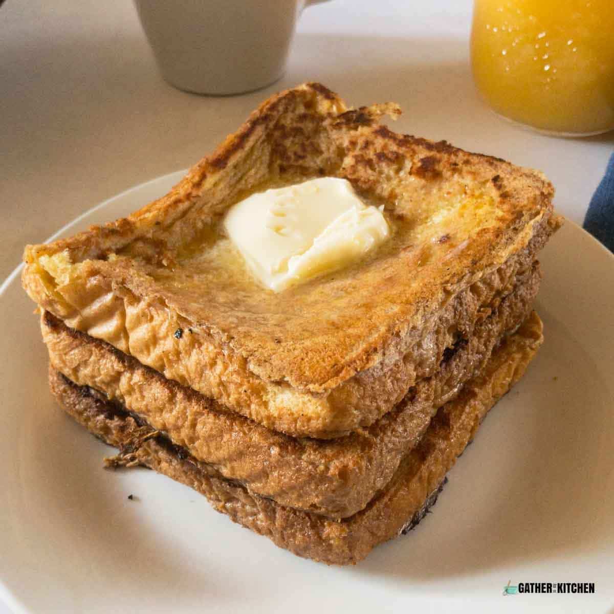 Buttermilk french toasts on a white plate.