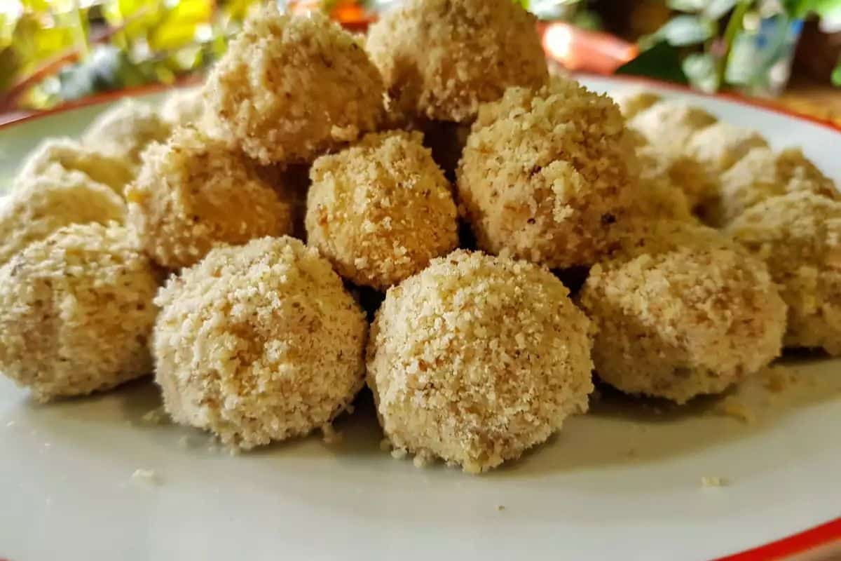 Crunchy lard balls with walnuts on a tray.