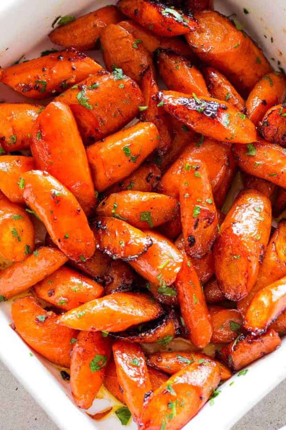 Honey butter garlic roasted carrots in a white bowl.