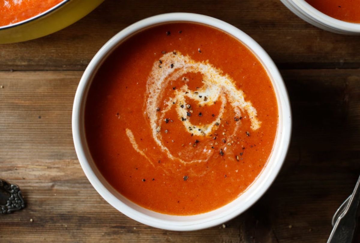 Healthy tomato soup in a white bowl.