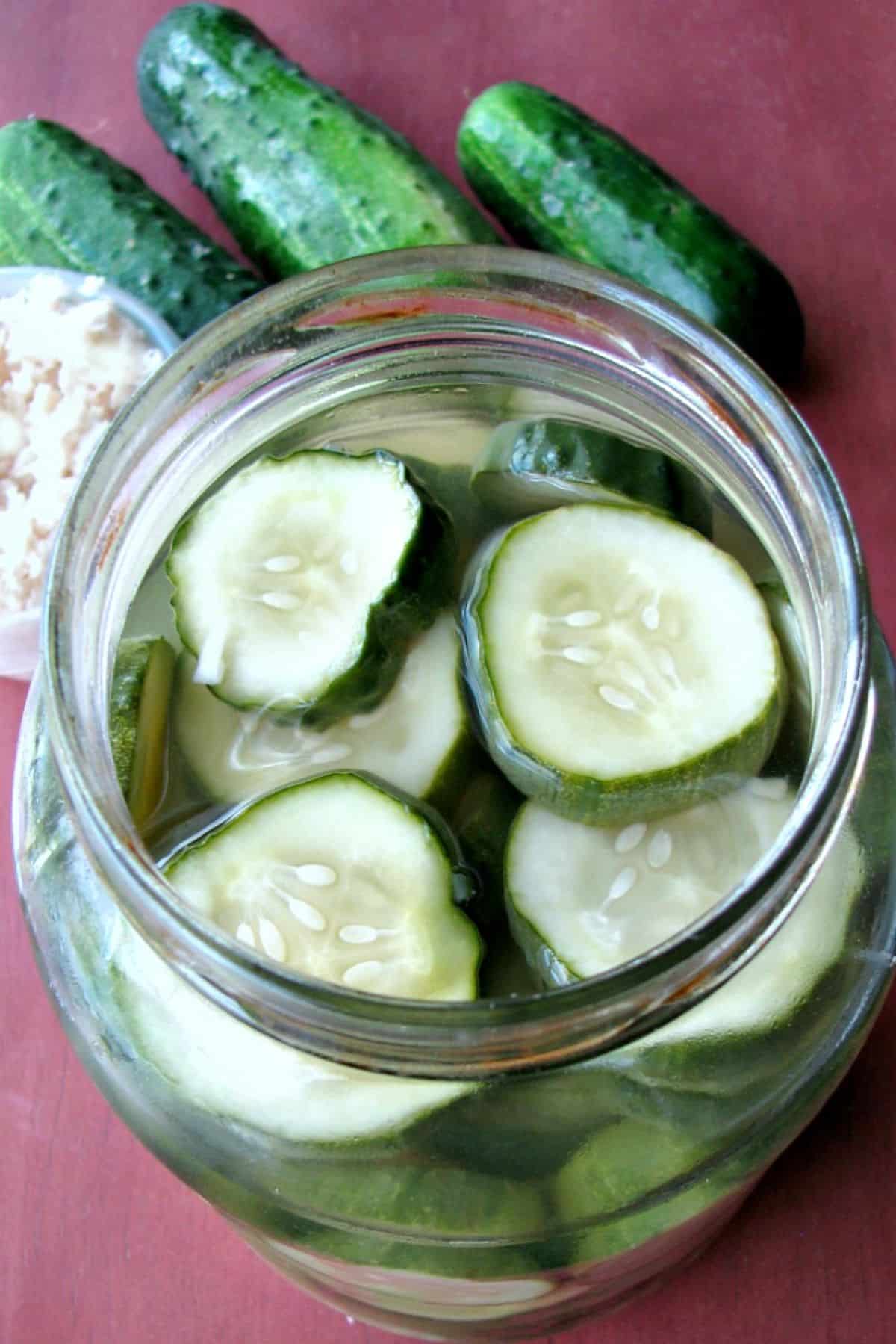 Sweet horseradish pickles in a glass jar.