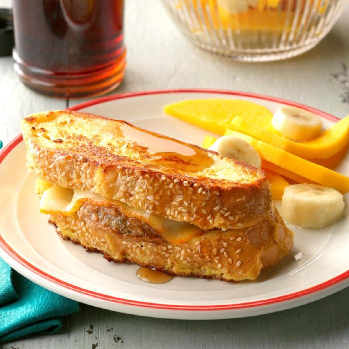 Sausage stuffed french toast on a white-red plate.