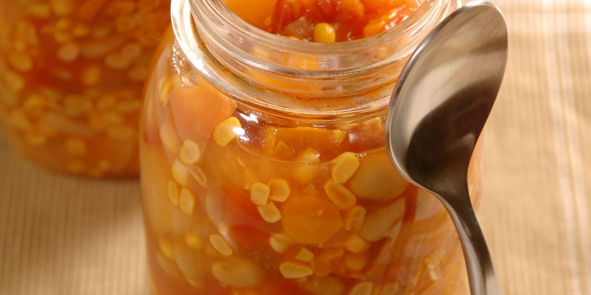 Canned garden vegetable soup in glass jars.