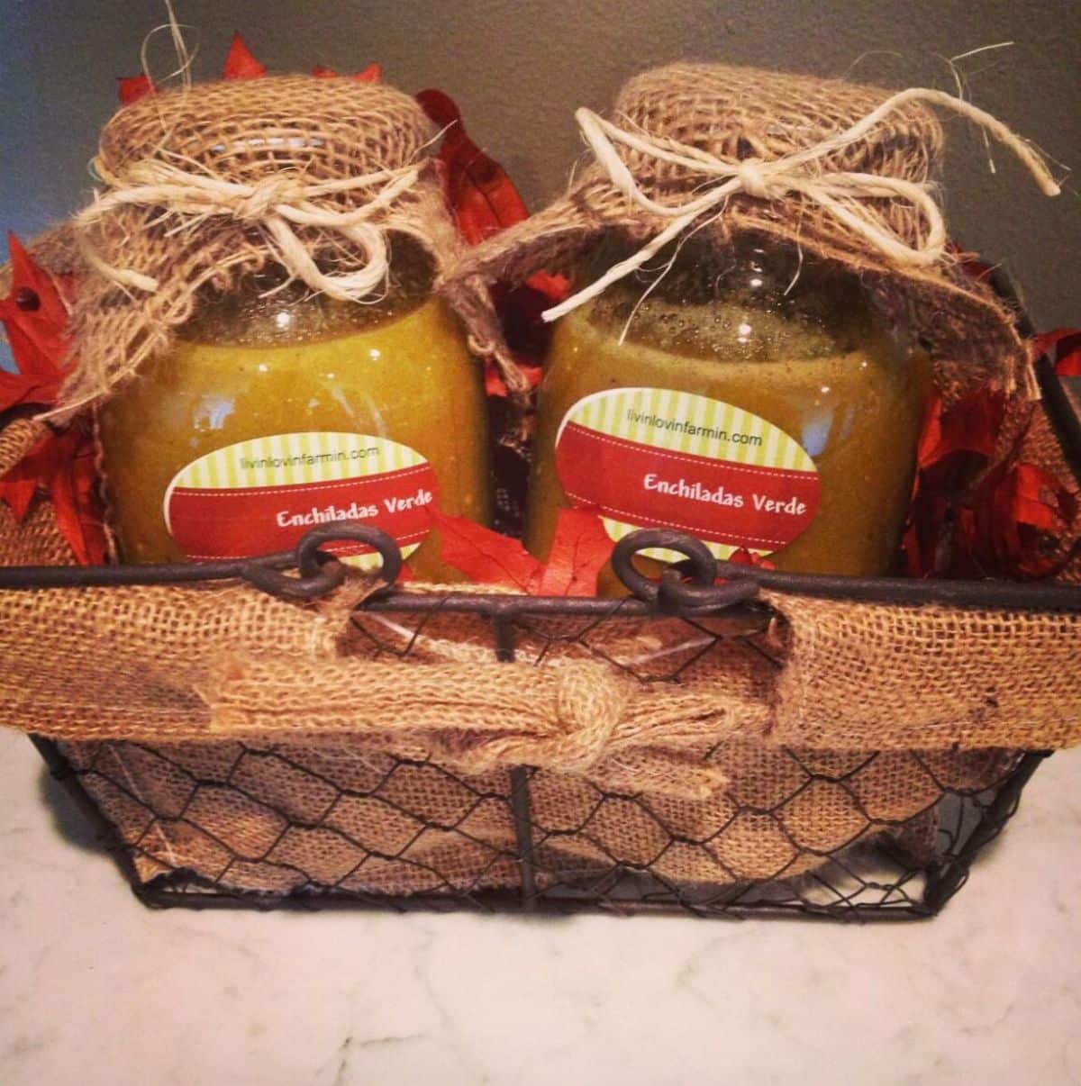 Green tomato enchilada sauce in two glass jars.