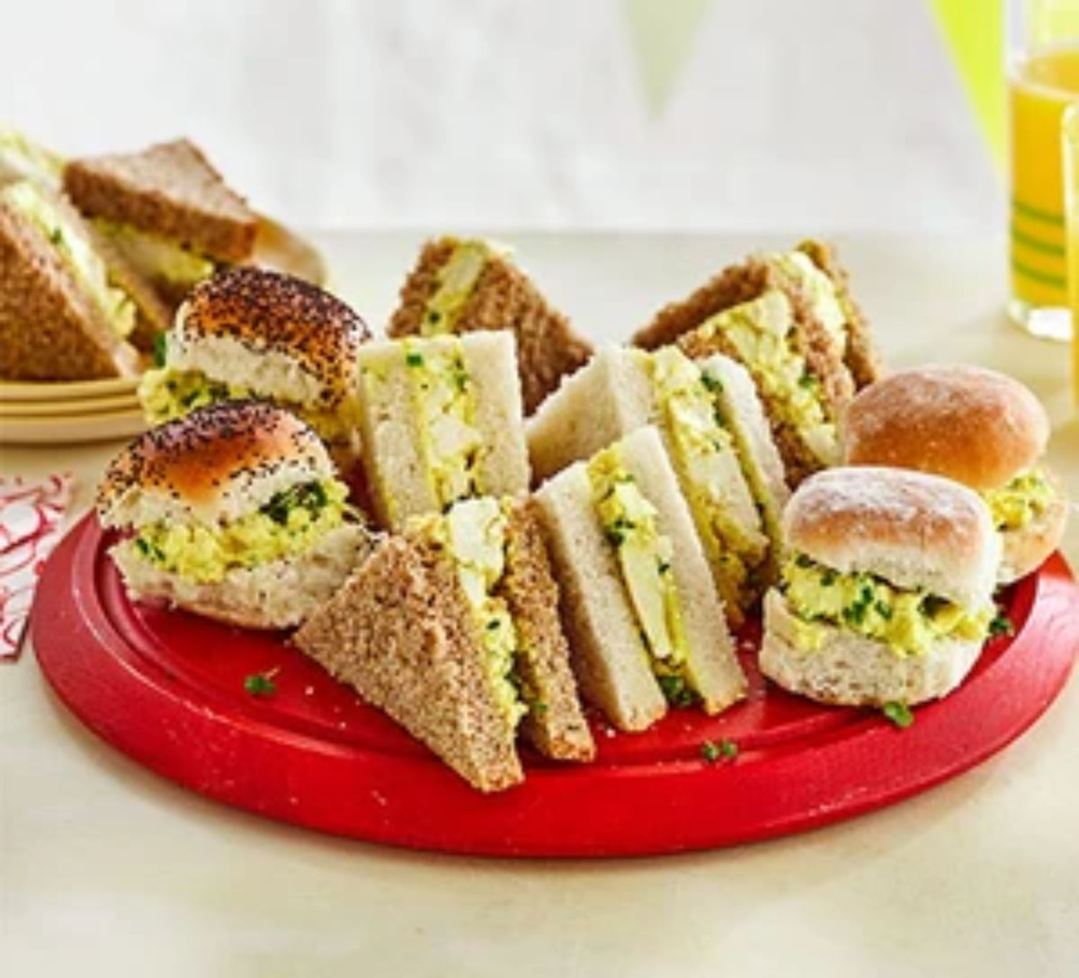 Eggless mayo sandwiches on a red tray.