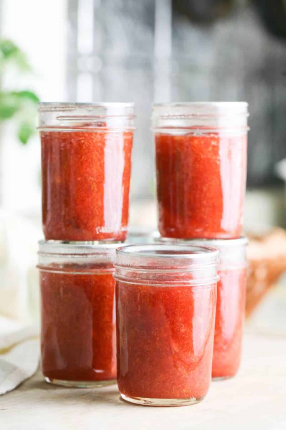 Delicious plum and apple jam in glass jars.