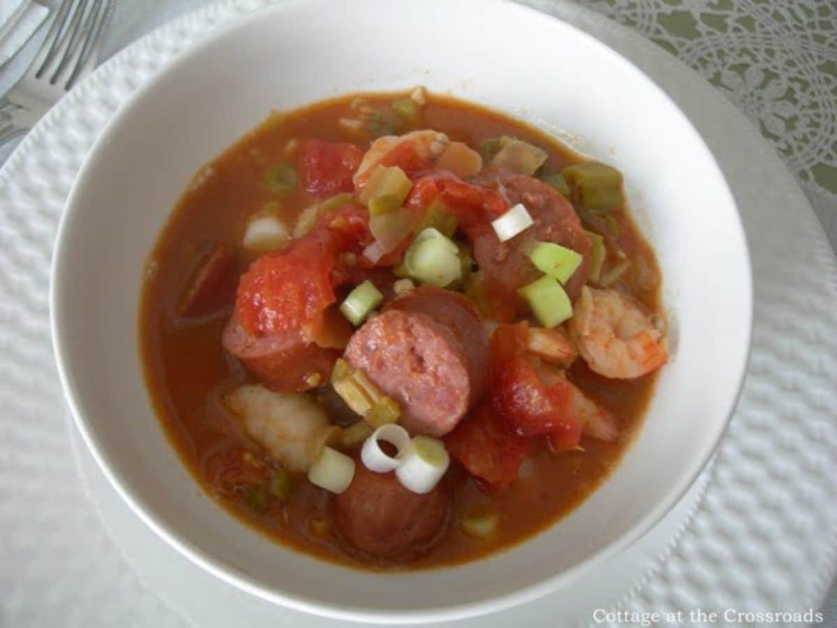 Seafood gumbo in a white bowl.