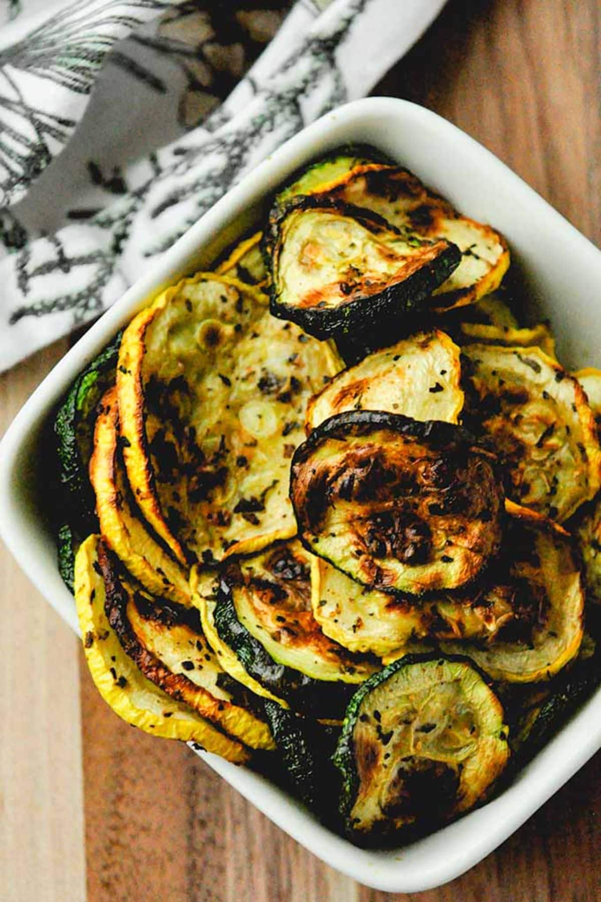 Air fryer squash and zucchini in a white bowl.