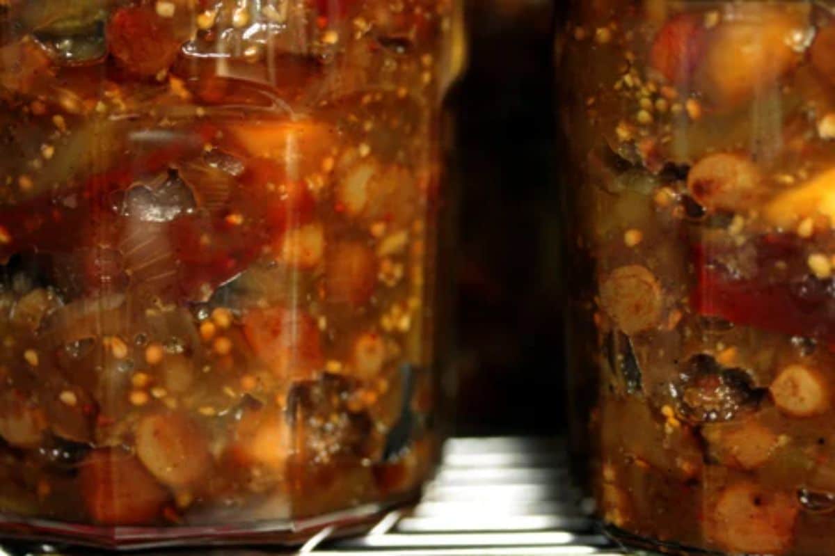 Green tomato apple chutney canned in glass jars.