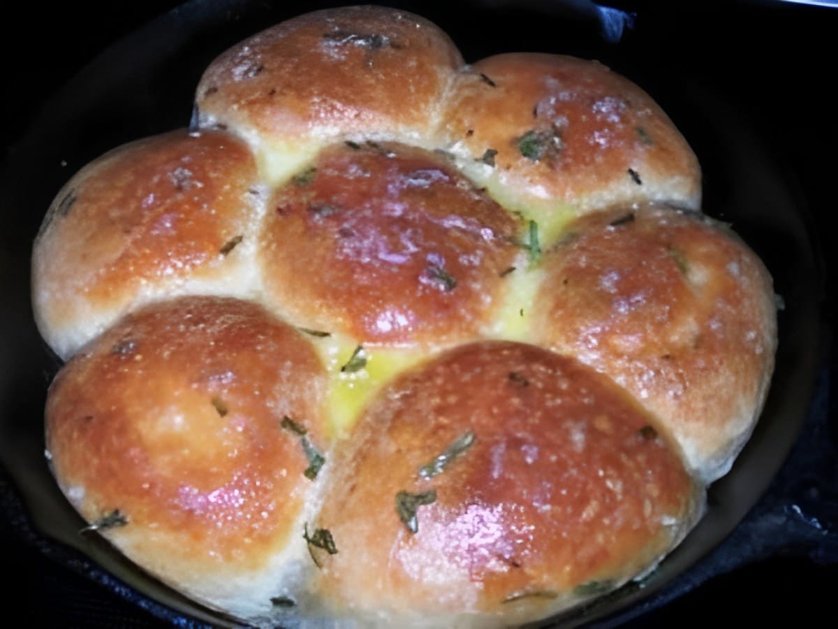 Delicious pioneer woman's buttered rosemary rolls in a bowl.