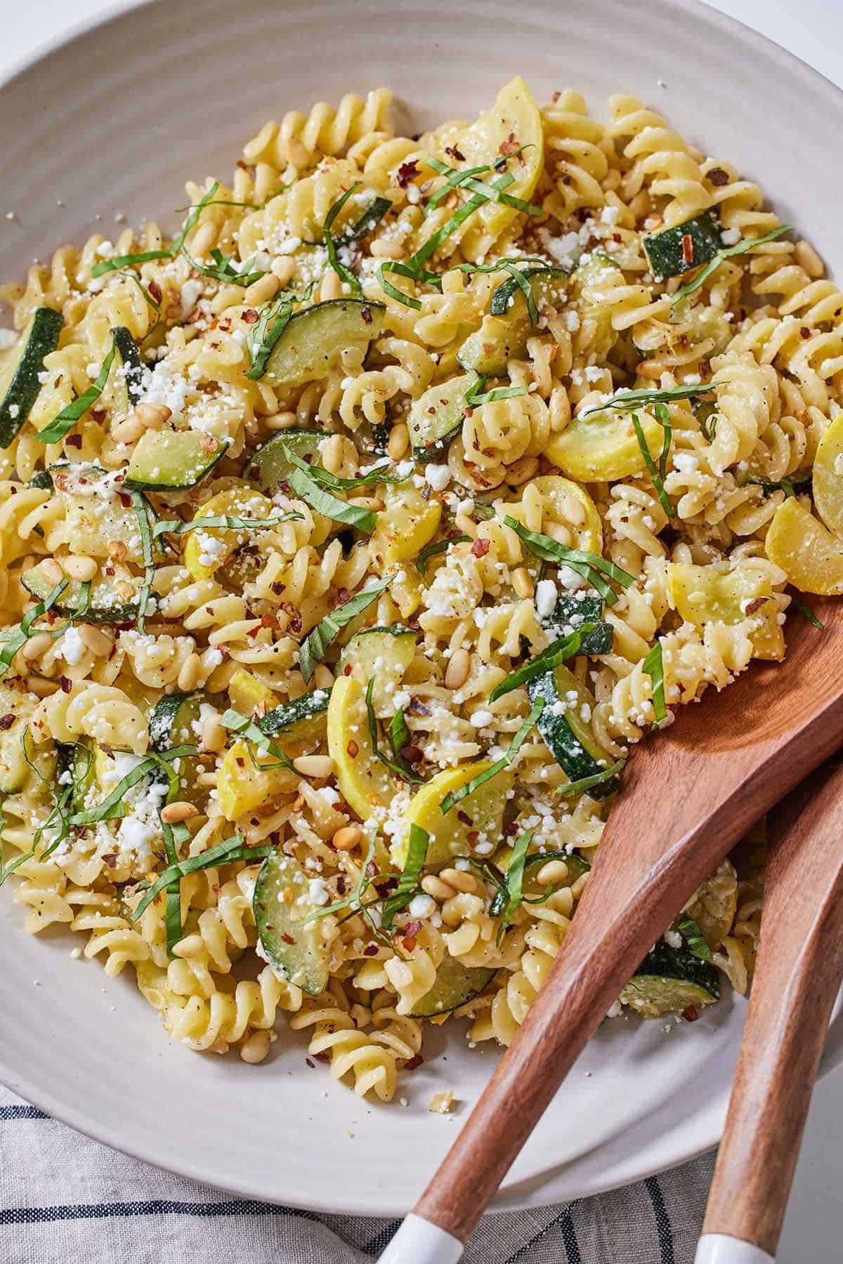 Summer squash pasta on a white plate.