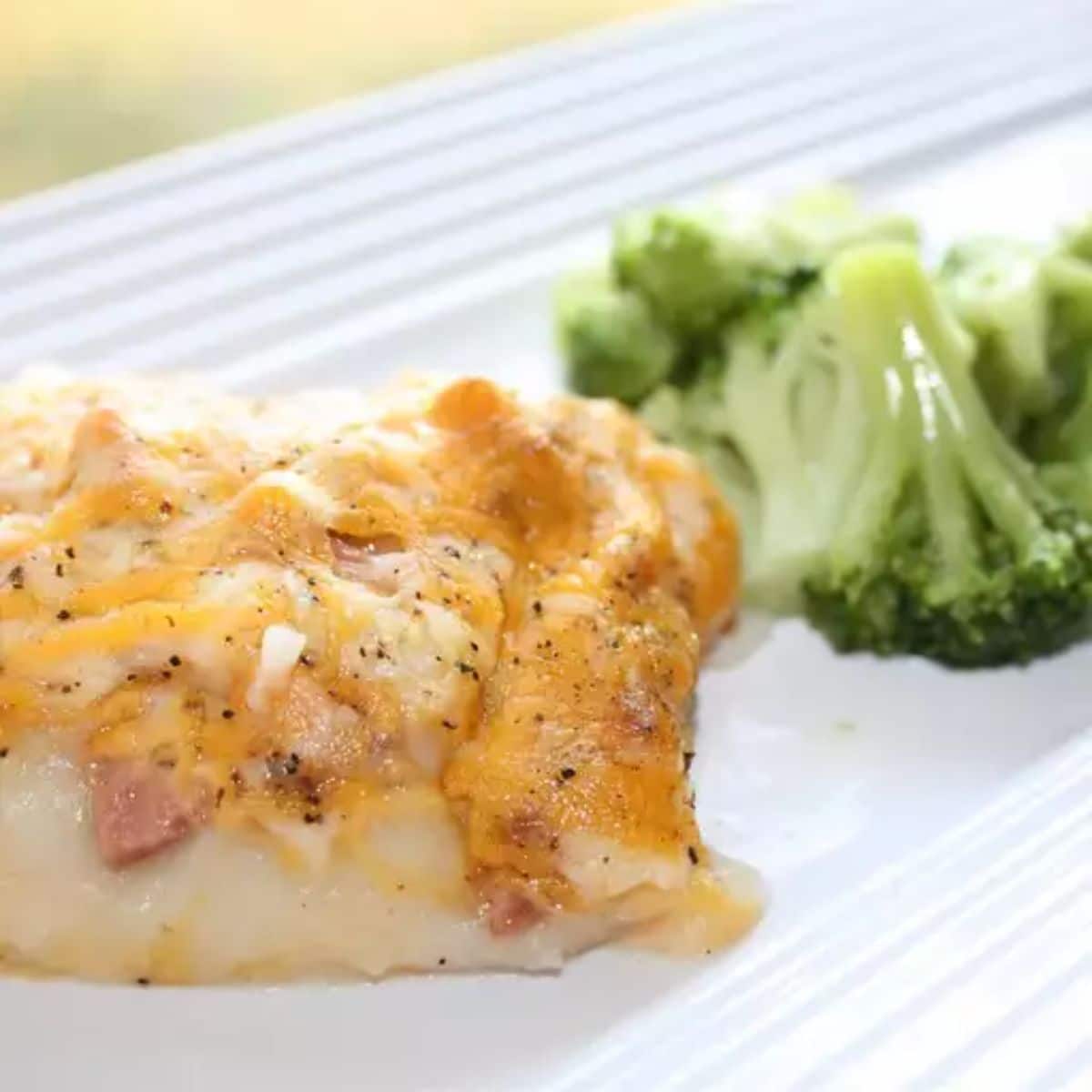 A piece of bologna casserole on a white tray.