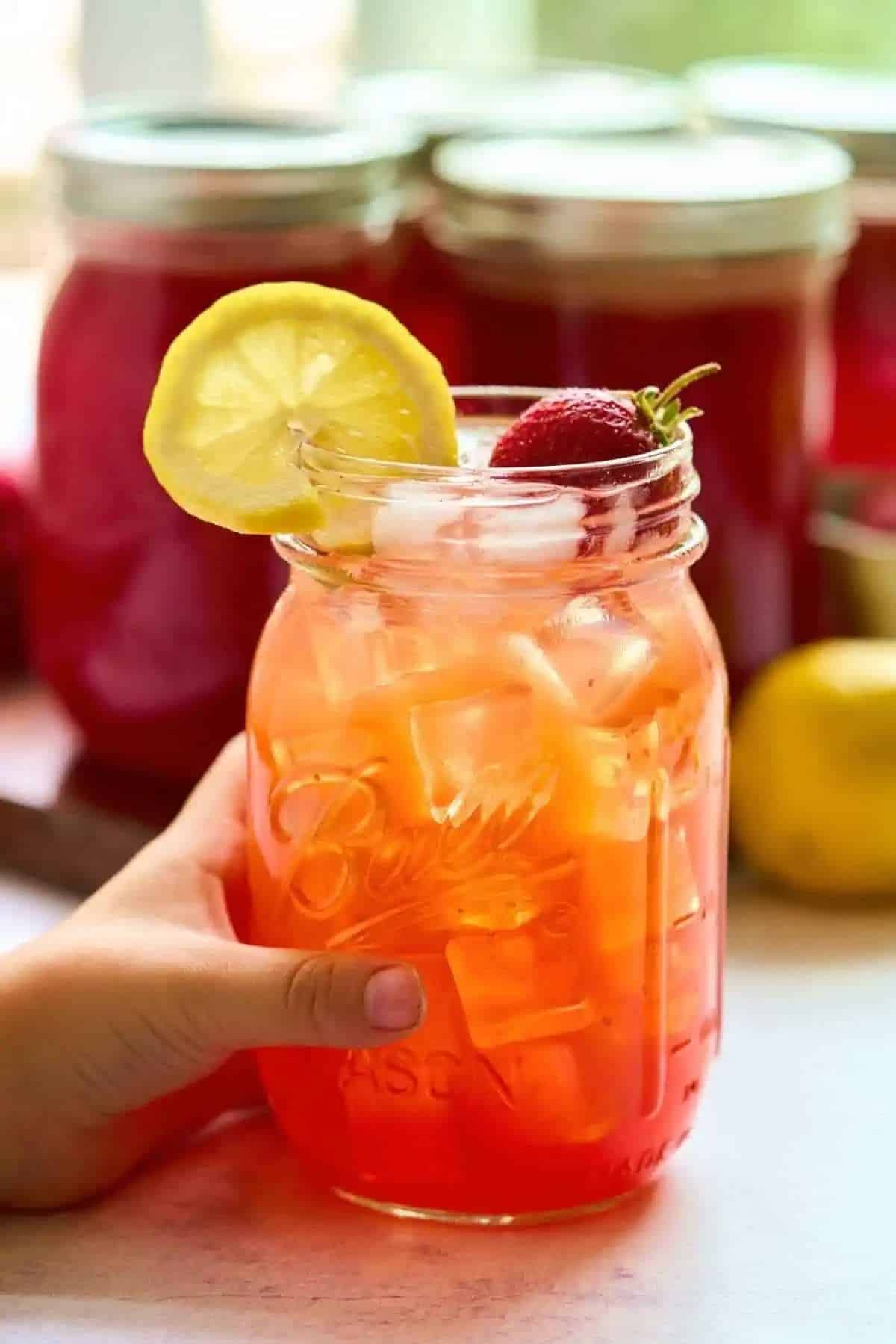 Strawberry lemonade concentrate in a glass jar.