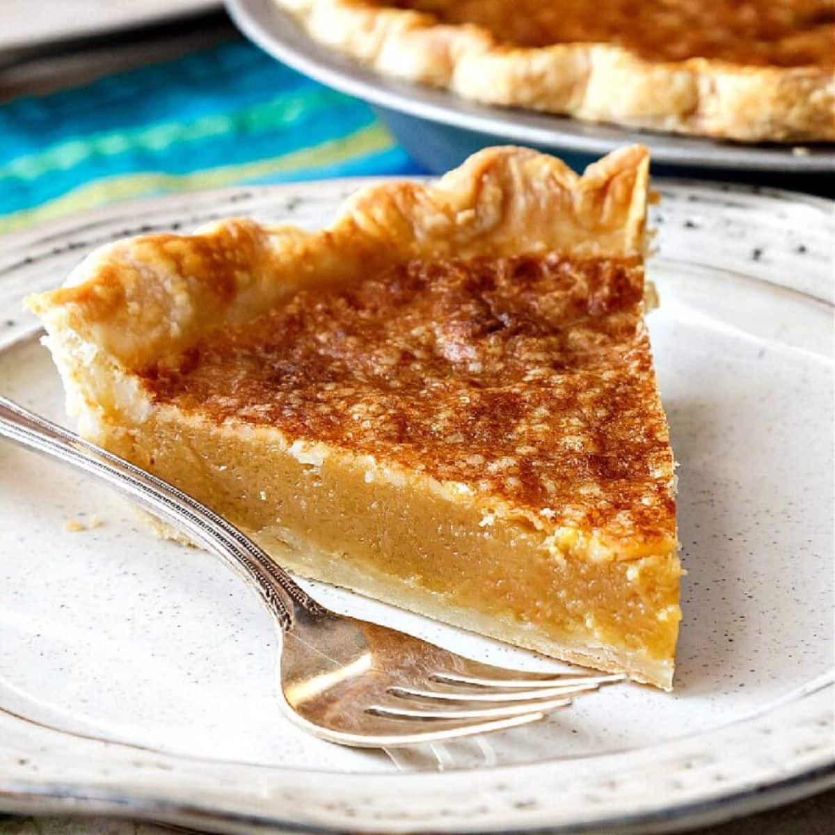 A piece of vinegar pie on a plate with a fork.