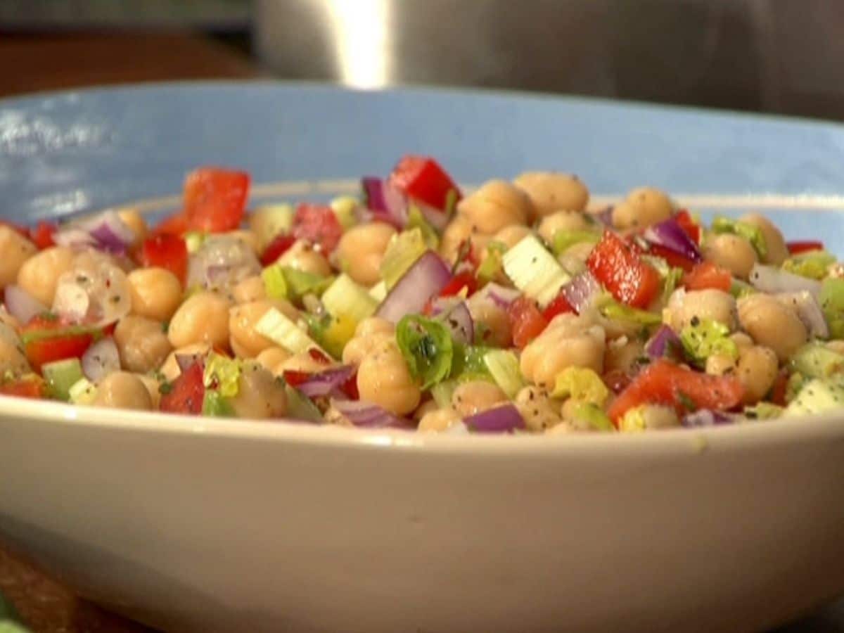 Healthy chickpea green salad in a white bowl.