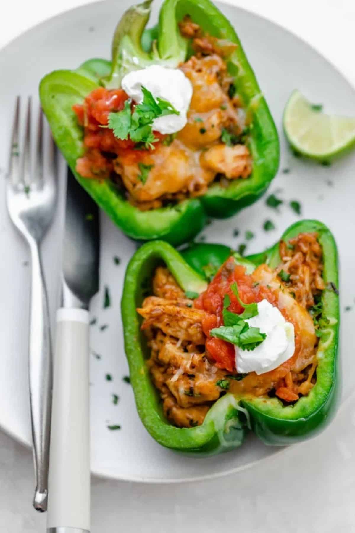 Healthy fajita peppers on a white plate with cutlery.