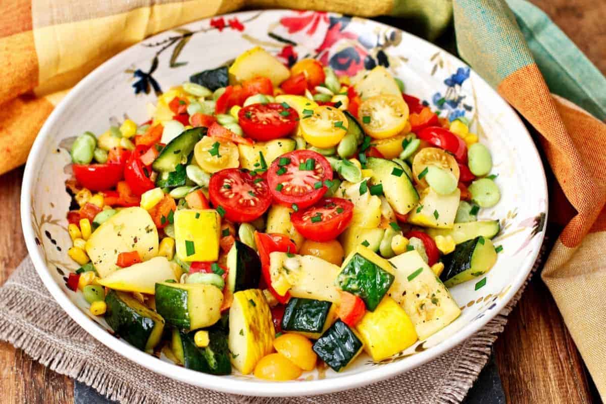 Summer squash succotash on a white plate.