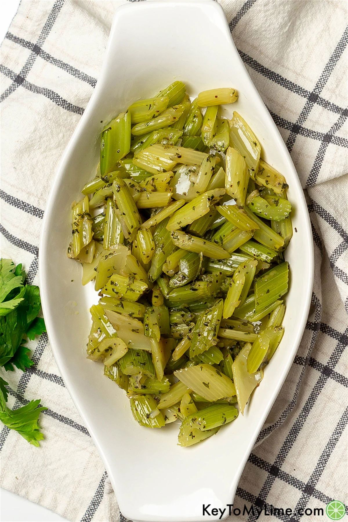 Braised celery on a white tray.