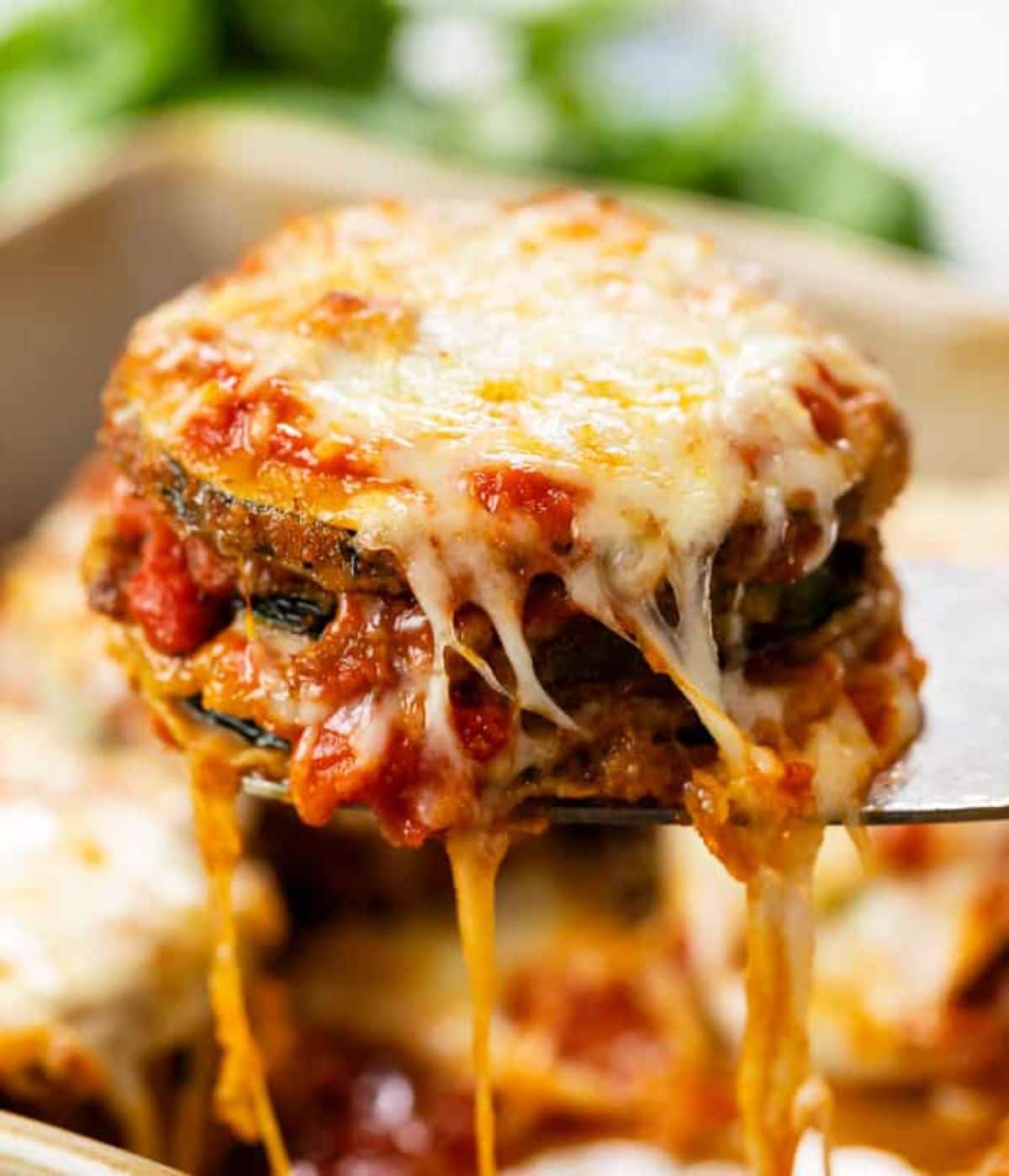 Zucchini parmesan on a spatula.