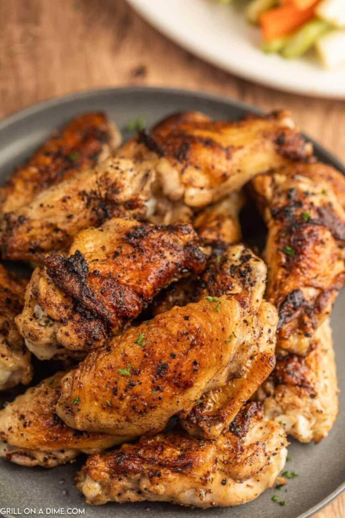 Blackstone chicken wings on a gray tray.