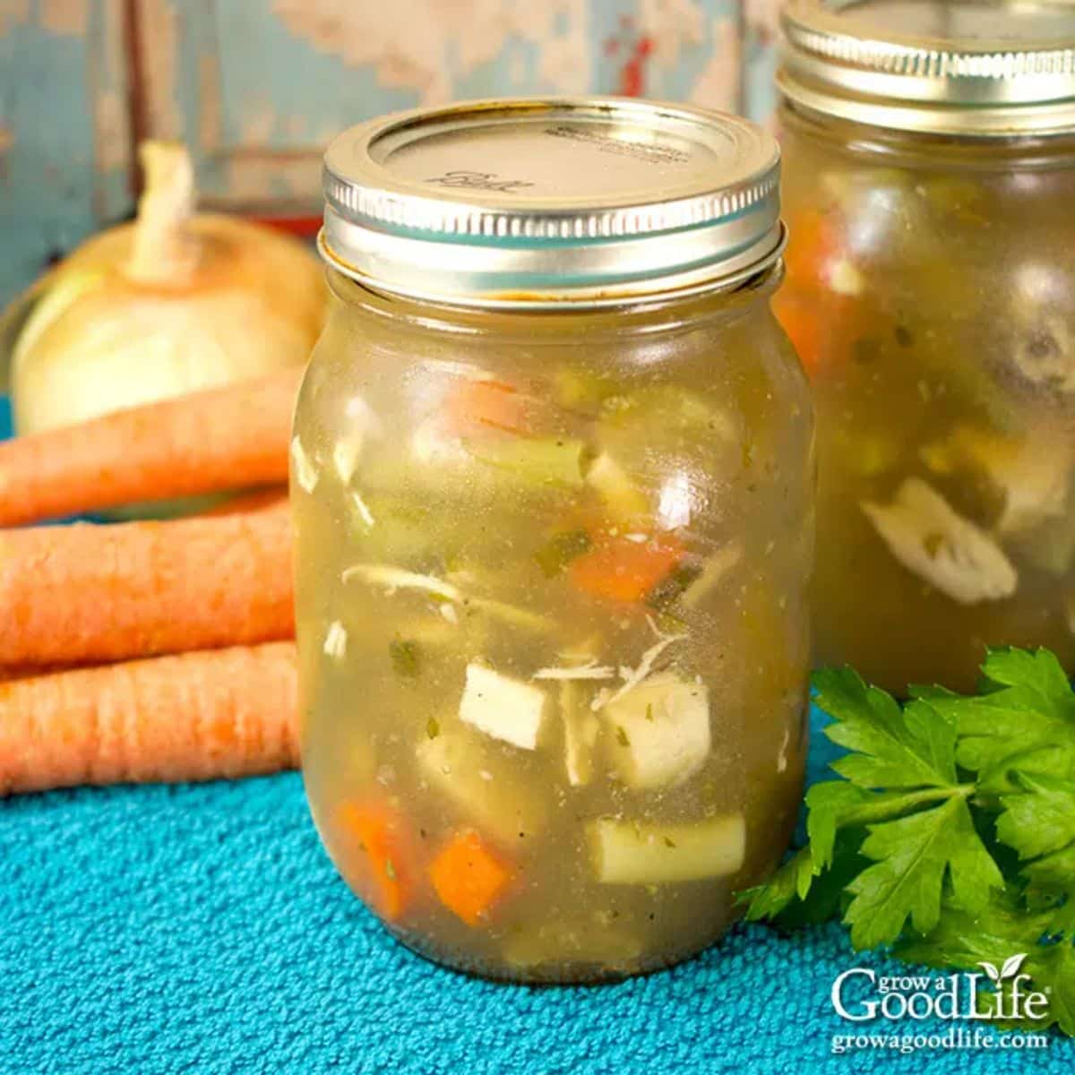Canned chicken soup in glass jars.