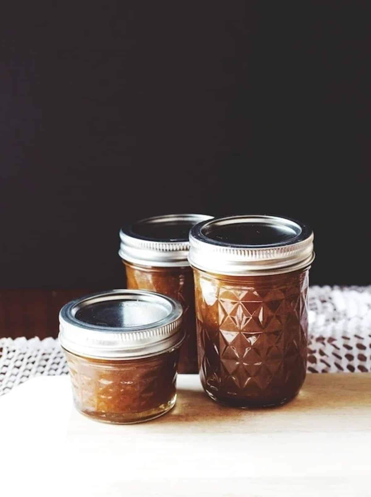 Brown sugar pear jam in three glass jars.