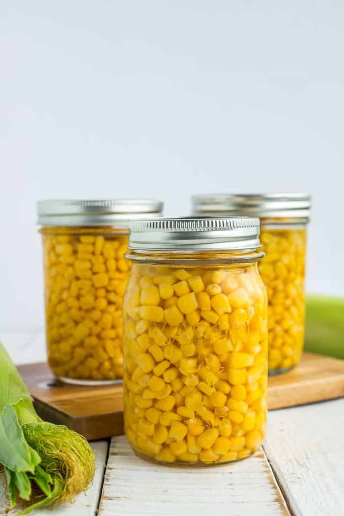 Homemade canned corn in glass jars.
