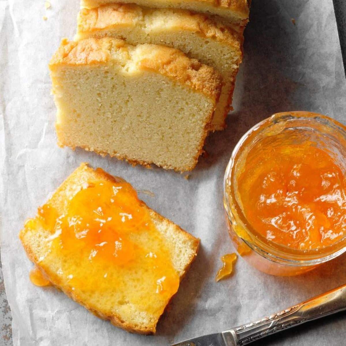 Apricot amaretto jam in a glass jar and on a slice of bread.