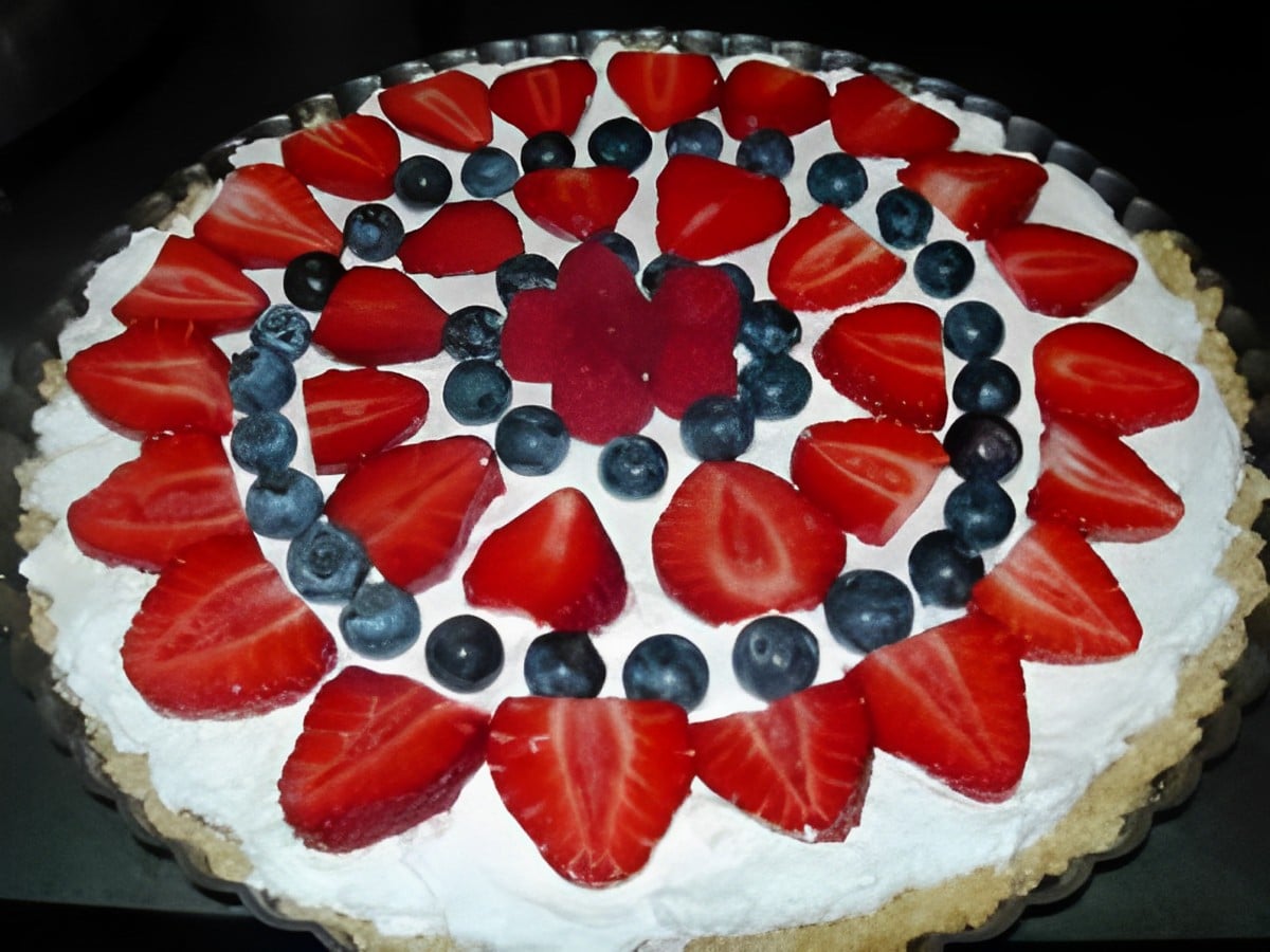 Delicious triple berry tart on a tray.