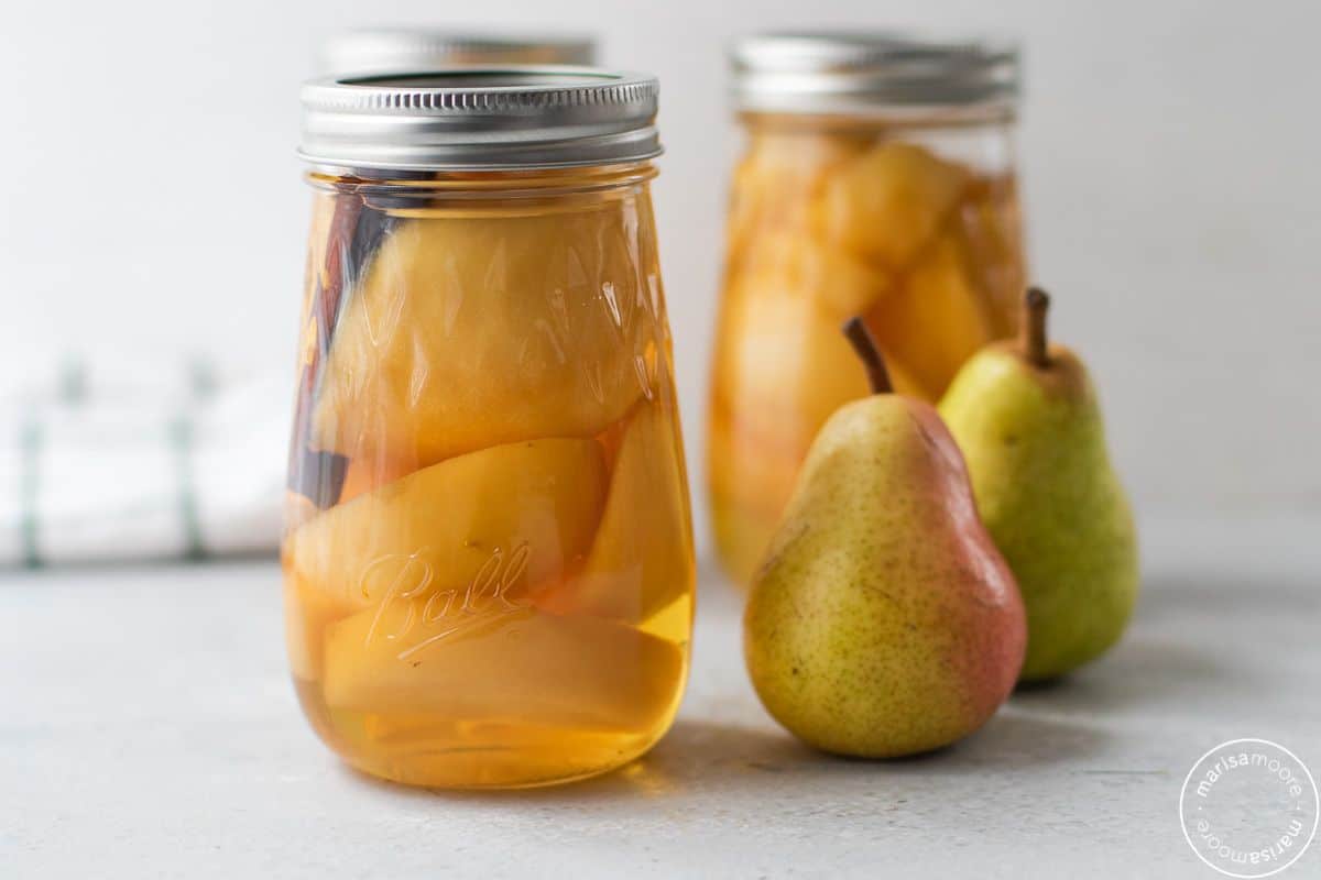 Cinnamon pears canned in glass jars.