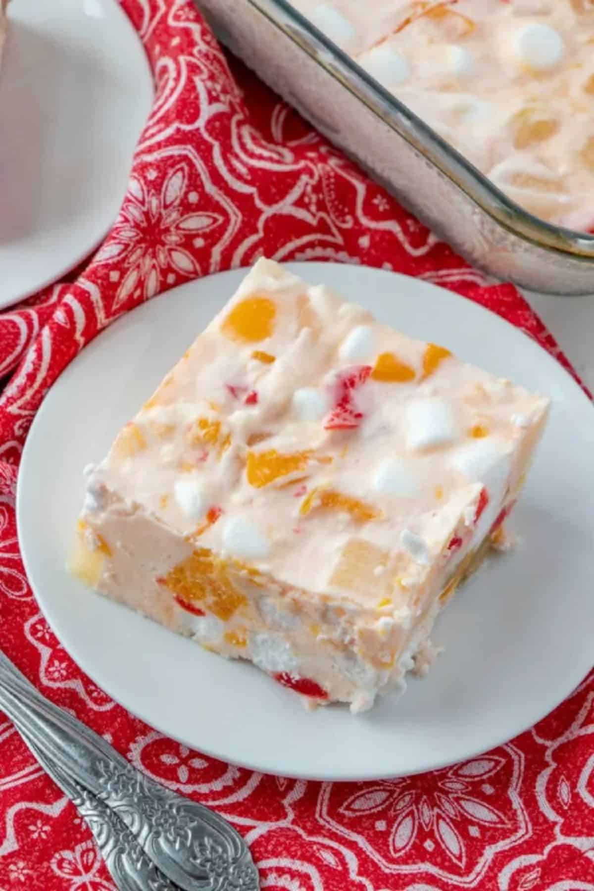 A piece of frozen fruit salad on a white plate.