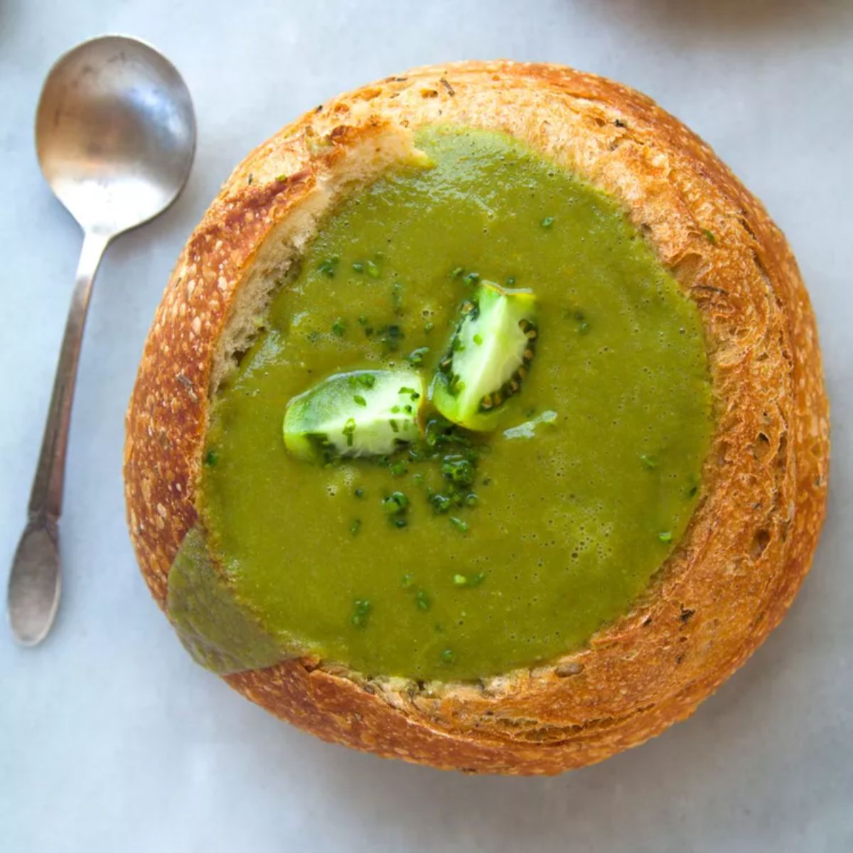Green tomato basil soup in a loaf of bread.