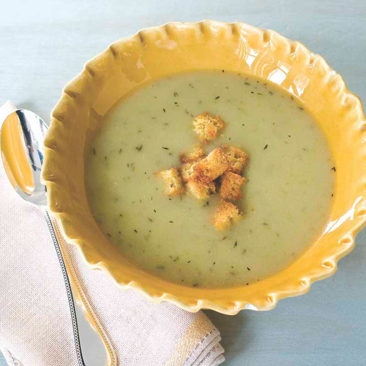 Fried green tomato soup in a yellow bowl.