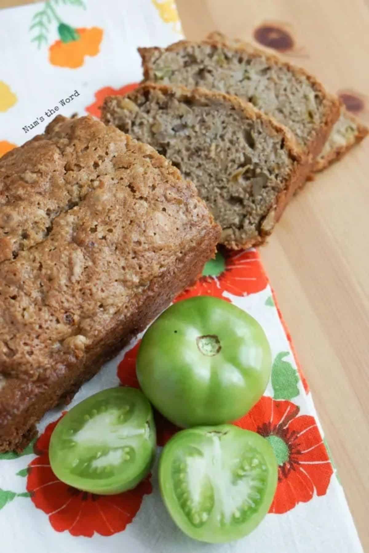 A partially sliced loaf of green tomato quick bread.