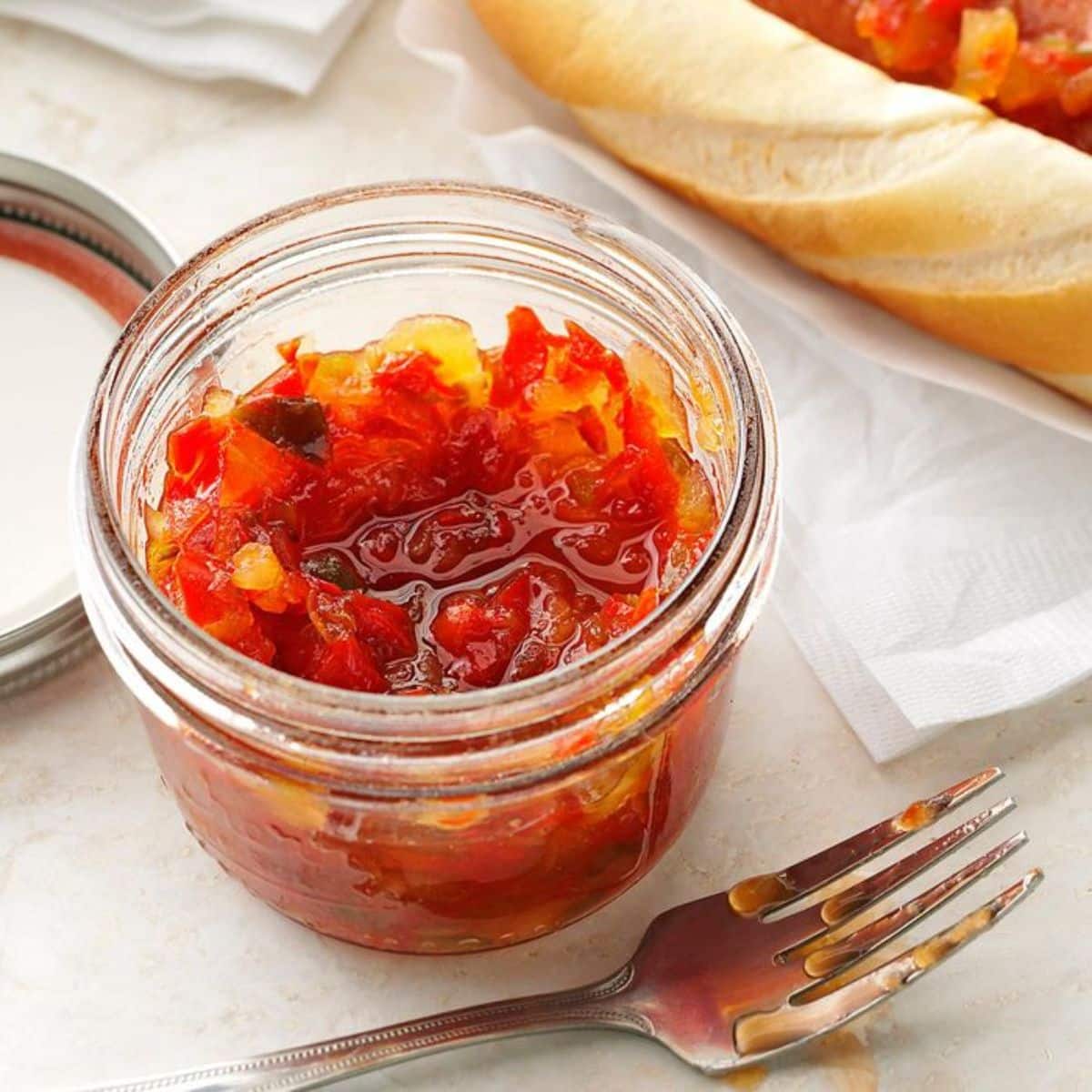 Autumn pepper relish in a glass jar.