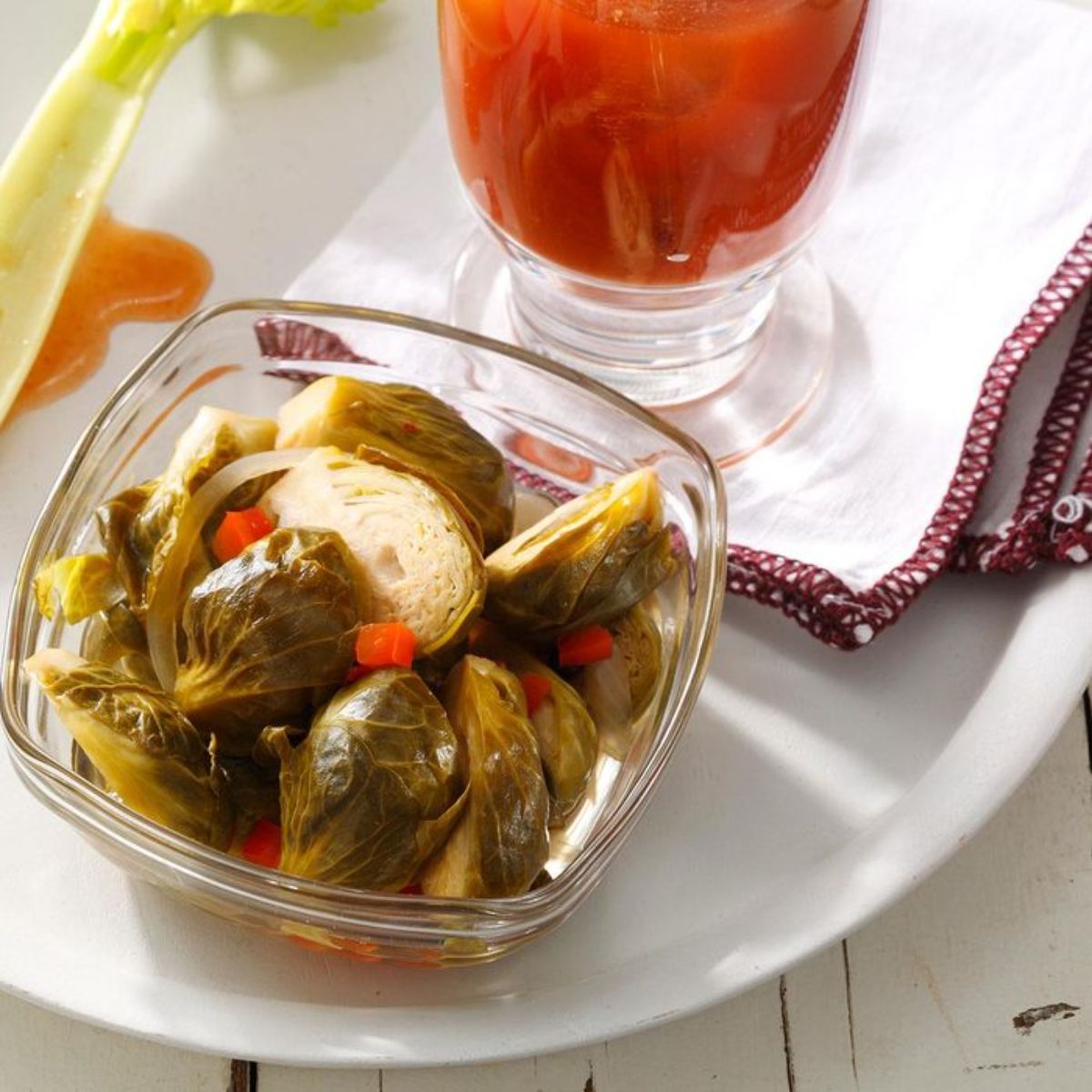 Pickled brussels sprouts in a glass bowl.