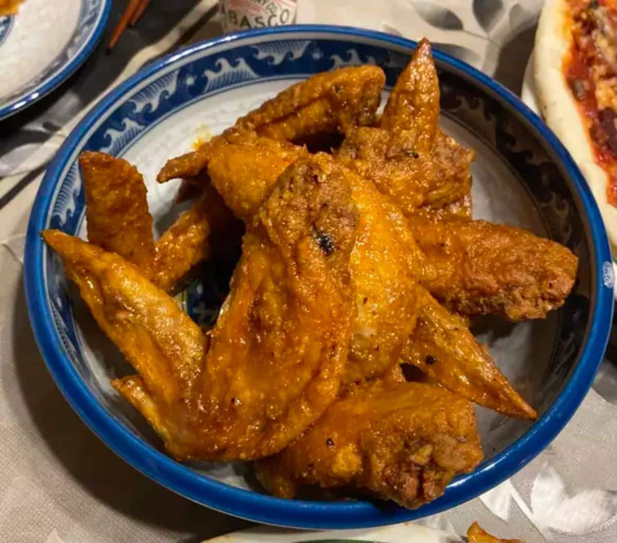 Delicious buffalo wings in a blue bowl.