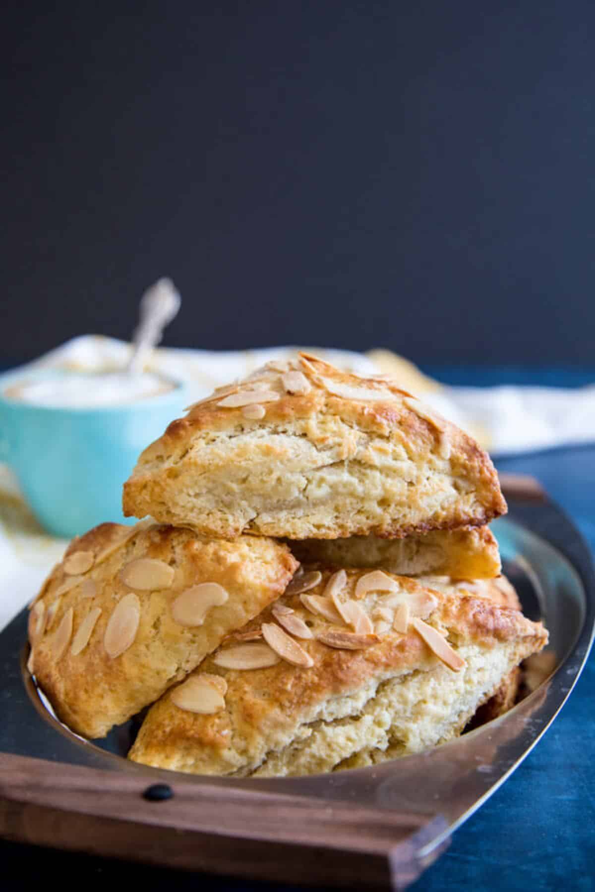 A pile of almond scones on a tray.