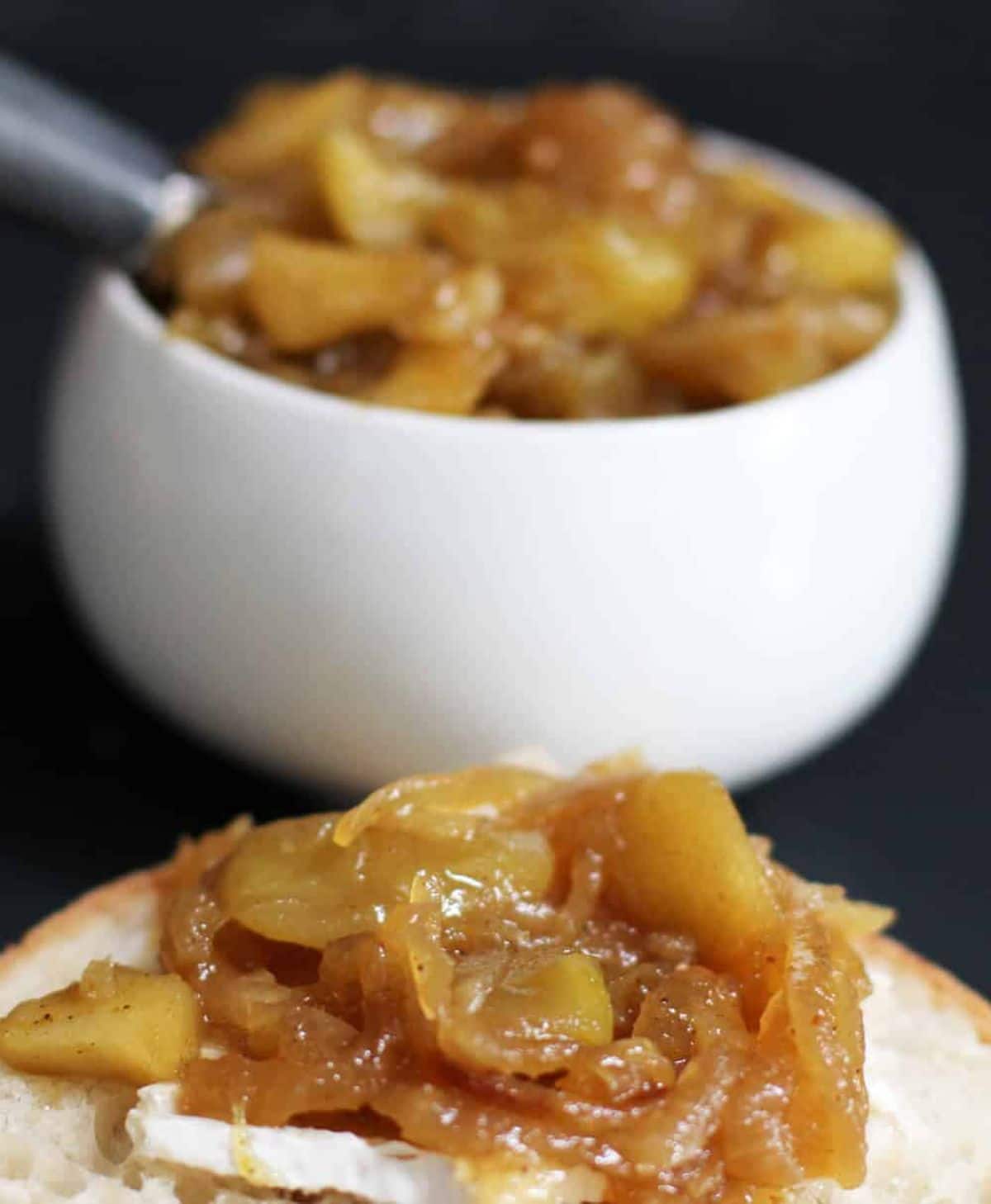 Apple and caramelized onion chutney on a piece of bread.