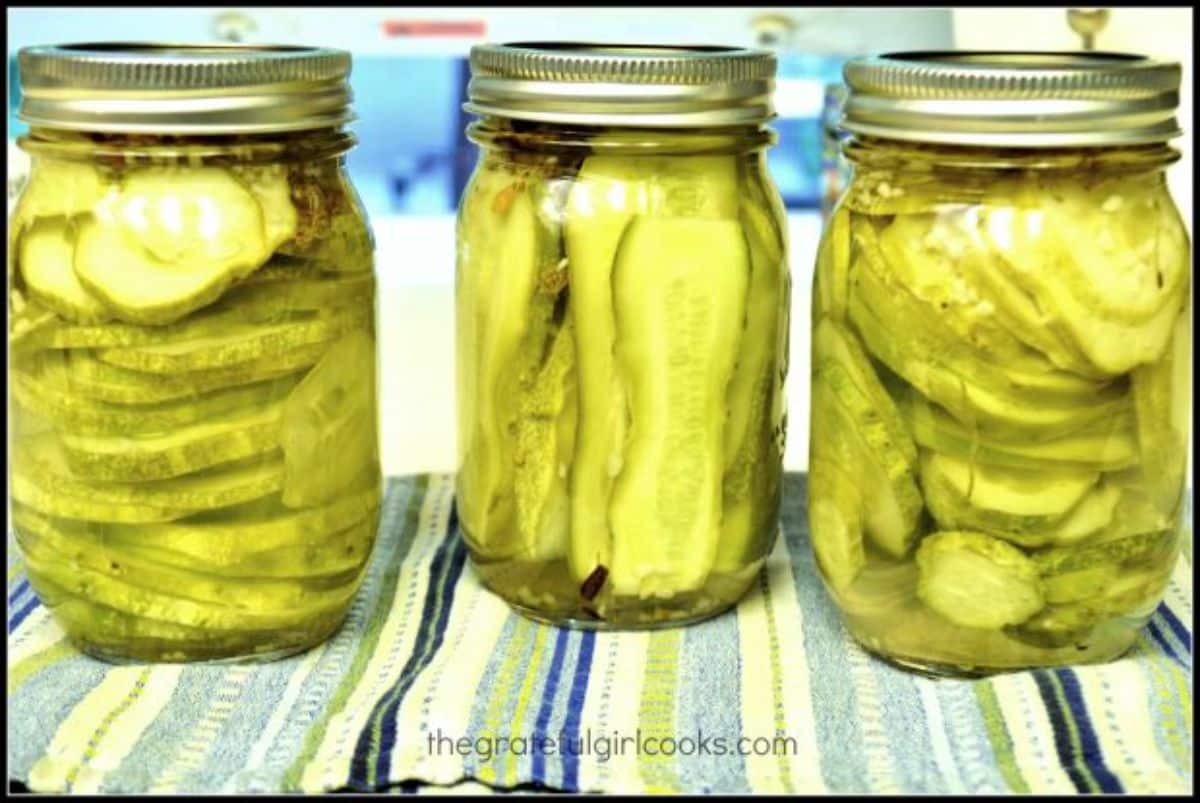 Crunchy garlic dill pickles in glass jars.
