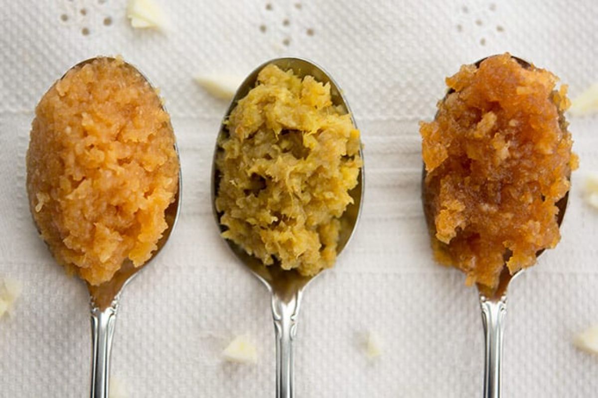 Fermented garlic paste on three spoons.